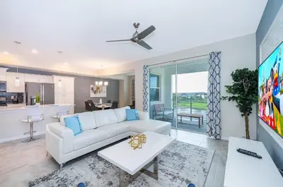 a living room with a white couch and a table at 3151-307BE STOREY LAKE, CONDO 2/2 LAKE VIEW in Kissimmee