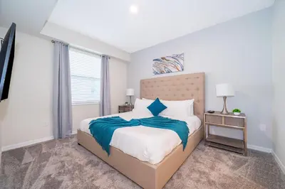 a bedroom with a large bed and a window at 3161-203FC STOREY LAKE, CONDO 2/2 LAKE VIEW in Kissimmee
