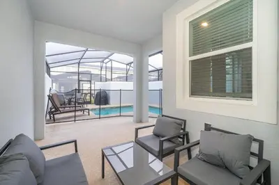 a living room with a couch and chairs and a pool at 2984JP TOWNHOUSE 4 BEDROOMS & 3 BATHROOMS + POOL in Kissimmee