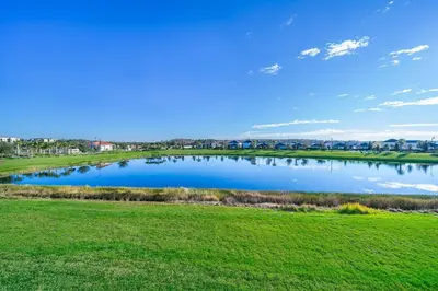 a large pond in a field with green grass at 3171-204AZ STOREY LAKE, CONDO 2/2 LAKE VIEW in Kissimmee