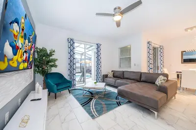 a living room with a couch and a table at 4202MC TOWNHOUSE 4 BEDROOMS & 3 BATHROOMS + POOL in Kissimmee