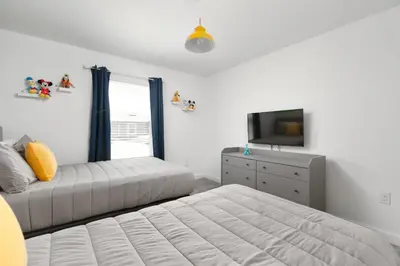 a bedroom with two beds and a tv and a dresser at Last Minute Disney Getaway Private Pool Themed Bedrooms. Book Now 56757 in Kissimmee