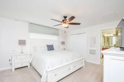 a bedroom with a white bed and a ceiling fan at Last Minute Disney Getaway Townhouse with Private Pool. Book Now 17066 in Kissimmee