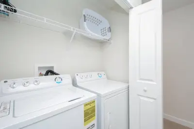 a white laundry room with white washer and dryer at Last Minute Disney Getaway Townhouse with Private Pool. Book Now 17066 in Kissimmee