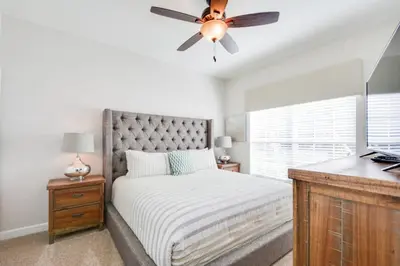 a bedroom with a bed and a ceiling fan at Last Minute Disney Getaway Townhouse with Private Pool. Book Now 17066 in Kissimmee