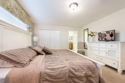 a bedroom with a large bed and a dresser at Last Minute Disney Getaway! Private Pool, Hot Tub & Games Room. Book Now! #17074 in Kissimmee