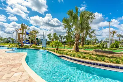 a swimming pool at a resort with palm trees at Last Minute Disney Getaway! Private Pool, Hot Tub & Games Room. Book Now! #17074 in Kissimmee