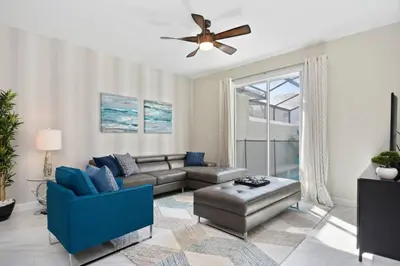 a living room with a couch and a ceiling fan at Last Minute Disney Getaway Private Pool Themed Bedrooms. Book Now 17142 in Kissimmee