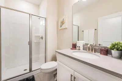 a bathroom with a toilet and a sink and a shower at Last Minute Disney Getaway Townhouse with Private Pool. Book Now 21174 in Kissimmee