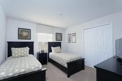 a bedroom with two beds and a flat screen tv at Last Minute Disney Getaway Townhouse with Private Pool. Book Now 17058 in Kissimmee