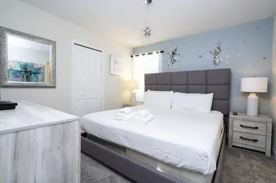 a bedroom with a large white bed and a window at Last Minute Disney Private Pool Hot Tub Game Room Themed Bedrooms. Book Now 29466 in Kissimmee
