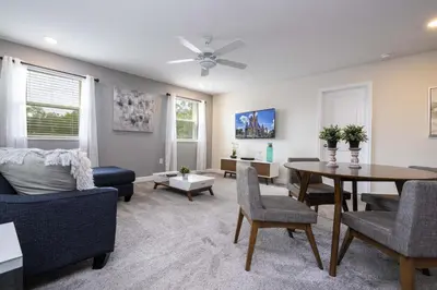 a living room with a couch and a table at Last Minute Disney Private Pool Hot Tub Game Room Themed Bedrooms. Book Now 29466 in Kissimmee