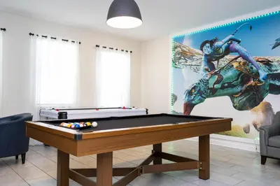 a room with a pool table and a mural at Last Minute Disney Private Pool Hot Tub Game Room Themed Bedrooms. Book Now 29466 in Kissimmee