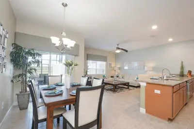 a kitchen and living room with a table and chairs at Last Minute Disney Getaway! Private Pool, Hot Tub & Games Room. Book Now! #17050 in Kissimmee