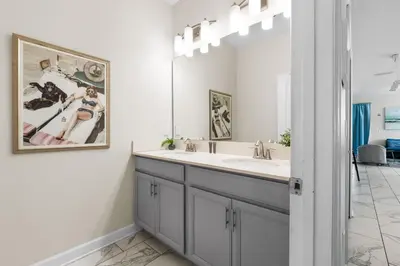 a bathroom with a sink and a mirror at Roomy Family Home-Sleeps 16 STL110 in Kissimmee