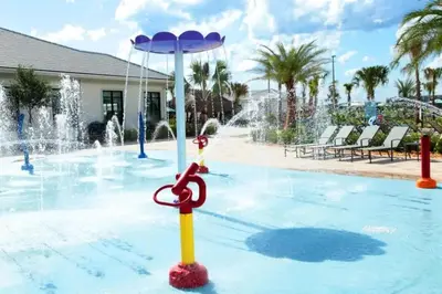 a pool with a water fountain with a pair of scissors at Roomy Family Home-Sleeps 16 STL110 in Kissimmee