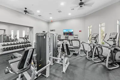 a gym with cardio equipment and treadmills at Epic Location 3BR Home w Full Comfort in Orlando