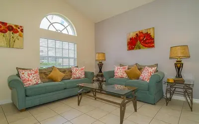 a living room with two couches and a window at 2025 Vacation Savings Secure Your Spot Today in Orlando