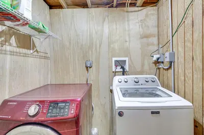 a kitchen with a stove and a washing machine at Patio and Grill Idyllic Sorrento Vacation Home! in Sorrento