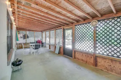 a large room with windows and a table and chairs at Patio and Grill Idyllic Sorrento Vacation Home! in Sorrento