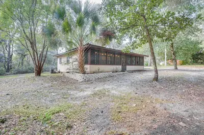 a house with a palm tree in a field at Patio and Grill Idyllic Sorrento Vacation Home! in Sorrento