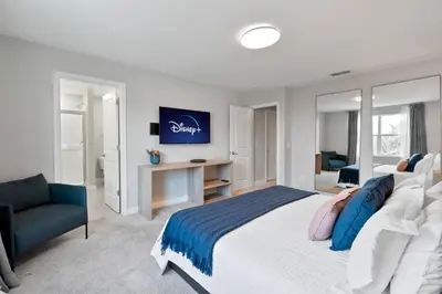 a bedroom with a bed and a desk and a couch at Luxury Villa 5BedroomsPool- 4 miles from Disney in Orlando