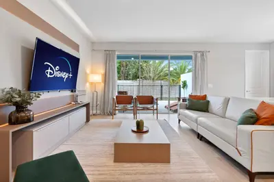 a living room with a couch and a tv at Luxury Villa 5BedroomsPool- 4 miles from Disney in Orlando