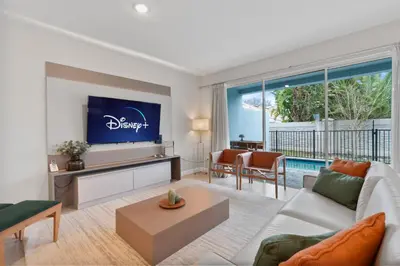 a living room with a couch and a tv at Luxury Villa 5BedroomsPool- 4 miles from Disney in Orlando