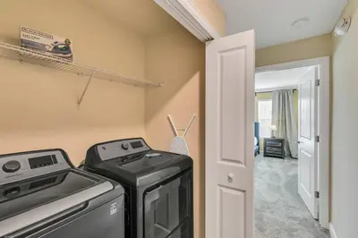a kitchen with a washer and dryer in a room at Stylish Family Home - Private Pool - STL111 in Kissimmee