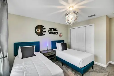 a bedroom with two beds and a chandelier at Stylish Family Home - Private Pool - STL111 in Kissimmee