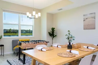 a dining room with a wooden table with chairs at Lovely Condo Access to Amazing Resort STL115 in Kissimmee