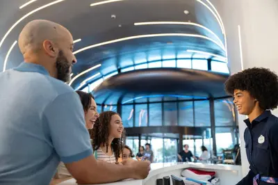 a group of people standing around a counter at Universal's Stella Nova Resort in Orlando