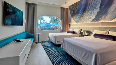 a hotel room with two beds and a window at Universal's Terra Luna Resort in Orlando