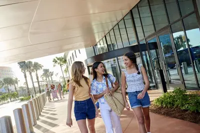 three women walking in front of a building at Universal's Terra Luna Resort in Orlando