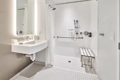 a white bathroom with a sink and a shower at Universal's Terra Luna Resort in Orlando