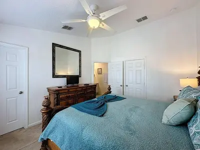 a bedroom with a bed and a ceiling fan at Sunnyside Up Gated Resort Style Community in Orlando