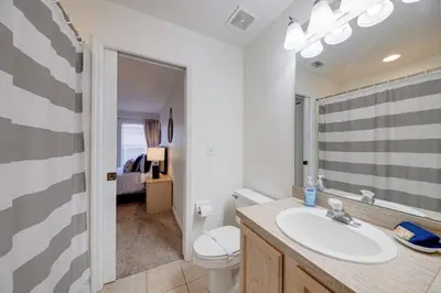 a white bathroom with a sink and a toilet at 5 Bedroom villa with private pool, close to disney in Kissimmee