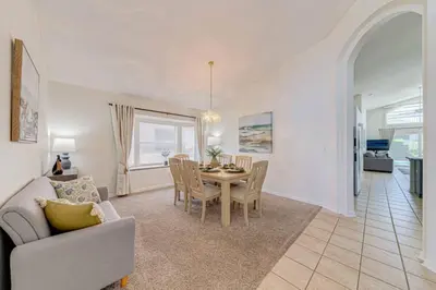 a living room with a table and a dining room at 5 Bedroom villa with private pool, close to disney in Kissimmee