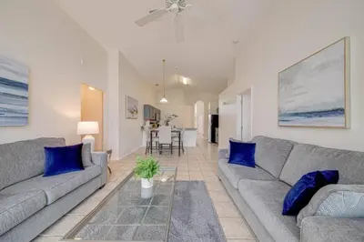 a living room with two couches and a table at 5 Bedroom villa with private pool, close to disney in Kissimmee