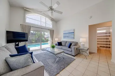 a living room with a couch and a table at 5 Bedroom villa with private pool, close to disney in Kissimmee