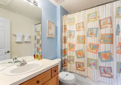 a bathroom with a sink and a shower curtain at Lilo and stitch Ohana Oasis in Kissimmee