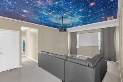 a living room with a ceiling with a star system at 30-Guest Home w Theme Rooms Games Resort Access in Kissimmee