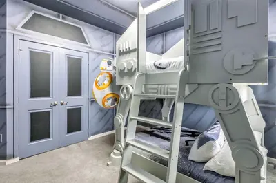 a bunk bed with a ladder in a room at 30-Guest Home w Theme Rooms Games Resort Access in Kissimmee
