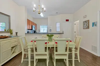 a kitchen with a dining room table and chairs at Esmerald Island Resort Oasis: Your Perfect Getaway Near Disney in Kissimmee