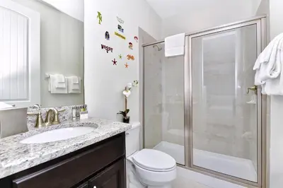 a bathroom with a shower and a toilet and a sink at Cheerful Home Near Disney With Private Pool, Themed Rooms And Waterpark & Resort Access At Encore Resorts Reunion - 7394Mr in Kissimmee
