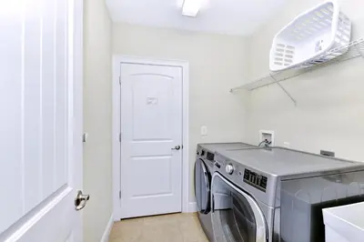 a laundry room with a washing machine in it at Gorgeous Home With Private Pool, Game Room Near Disney With Waterpark & Resort Access At Encore Resort - 781La in Kissimmee