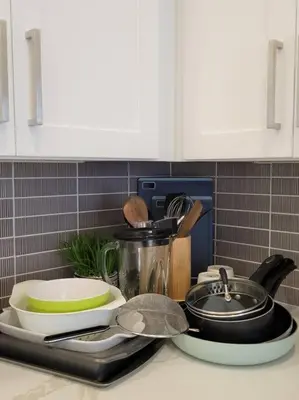 a kitchen counter with a sink with dishes and a pot at Elegant Cozy Spot to unwind! UCF/MCO/Parks/Beach in Orlando