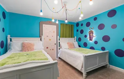 a childs bedroom with two beds and blue walls at Amazing 6Bdrms At Storey Lake- Close to Disney in Kissimmee