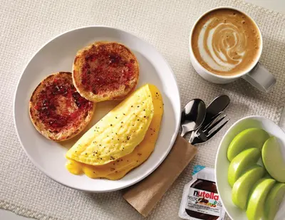a plate of food with eggs and toast and a cup of coffee at Home2 Suites By Hilton Winter Garden in Orlando