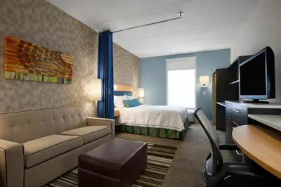 a hotel room with a bed and a desk at Home2 Suites By Hilton Winter Garden in Orlando